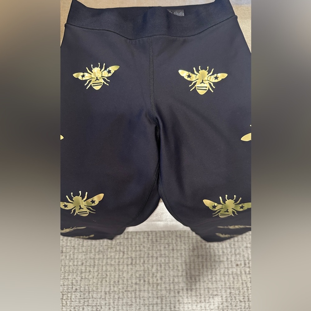 Ultracor size small black with gold bumblebee compression tights.